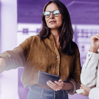 Mature business woman brainstorming with her colleague in an office