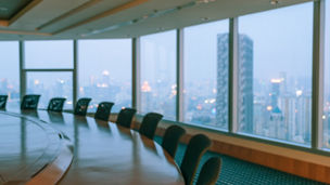 Blur image of empty boardroom with window cityscape background. Business concept