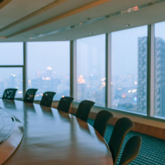 Blur image of empty boardroom with window cityscape background. Business concept