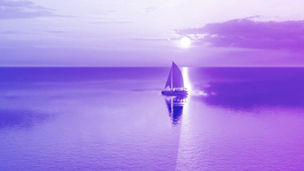 Boat in the middle of ocean at sunset