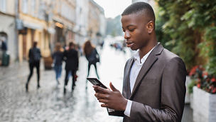 boy-on-street-looking-in-phone