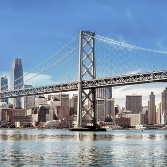 Bridge over waters against city line