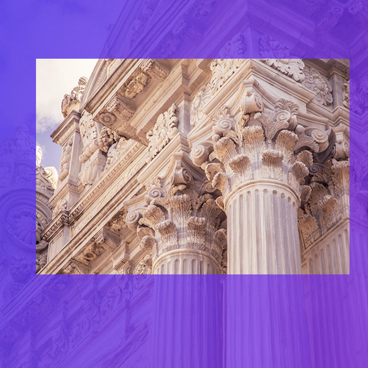 Building with decorative corinthian columns and frieze banner