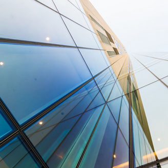 Glass modern building against bright sky