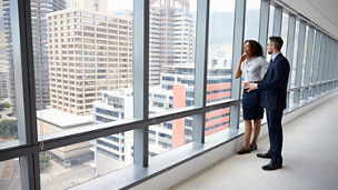 Portrait Of New Business Owners By Empty Office Window