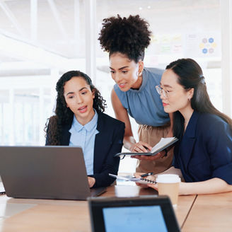 Poeple at the office looking at a laptop