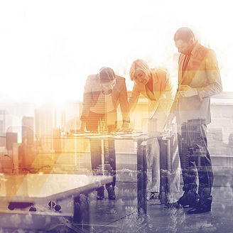 Business people at table going over numbers with city buildings in background