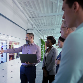 Business people in discussion looking at screen