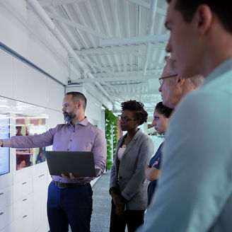 Business people in discussion looking at screen
