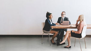 Business women and man sitting at a table having a discussion
