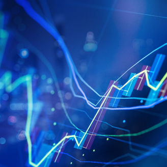 Close-up of colorful line graphs and candlestick chart elements over a blurred blue-toned background with circular light effects