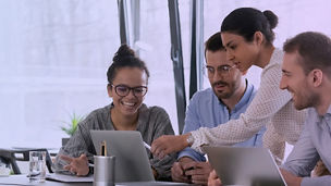 Business team meeting woman pointing pen at laptop screen