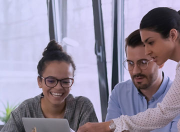 Business team meeting woman pointing pen at laptop screen