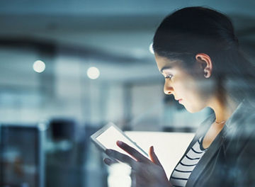 Business woman reading something on tablet