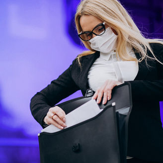 Business woman wearing mask outside the business center