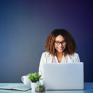 Businesswoman wearing spectacles, working on laptop