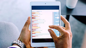 Mixed race businessman examining graph on digital tablet