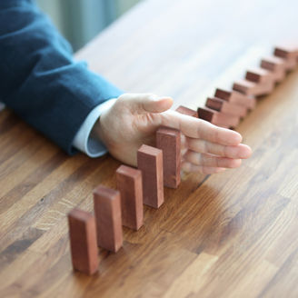Businessman hand separates wooden blocks on table. Making important management business decisions concept