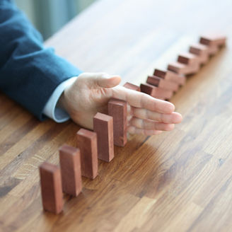 Businessman hand separates wooden blocks on table. Making important management business decisions concept