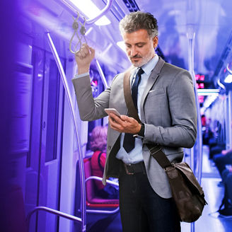 Man in metro kijkt naar telefoon