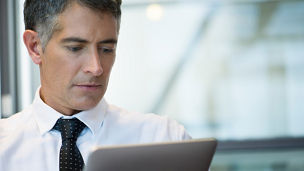 Businessman using digital tablet. Keywords: Tie, Business, Data, 50-54 Years, Mature Adult, Adult, Adults Only, Argentina, Buenos Aires, Business Person, Businessman, Busy, Colour Image, Communication, Connection, Convenience, Corporate Business, Day, Differential Focus, Digital Tablet, Electronic Book, Form Of Communication, Front View, Grey Hair, Headshot, Holding, Horizontal, Image Focus Technique, Indoors, Information Medium, Looking, Mature Men, Men, Occupation, One Man Only, One Mature Man Only, One Person, Only Mature Men, Only Men, Part Of, People, Photography, Portability, Professional Occupation, Reading, Shirt, Shirt and Tie, Simplicity, Smart, The Internet, Using Computer, Wireless Technology, Working 