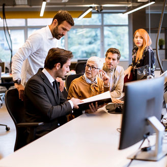 Senior businesswoman working together with young business people in the modern office