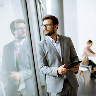 man-standing-next-to-window