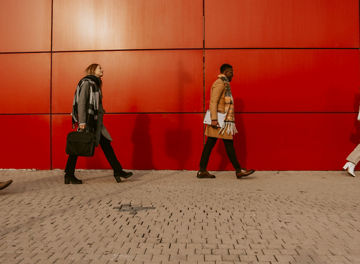 Person smiling whilst looking into the distance with trees in the background