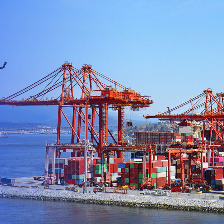 Vancouver port dock with cargo crane and helicopters flying