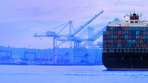 Cargo ship and cranes at harbor banner 