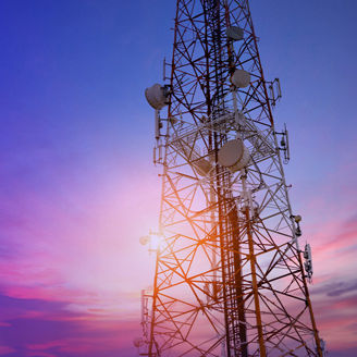 Cell tower against sunset banner