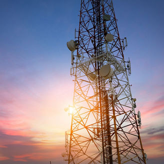 Cell tower against sunset