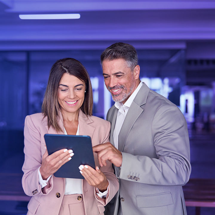 Two people looking at a tablet