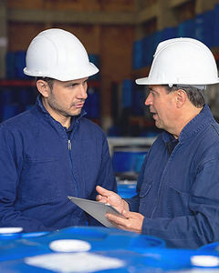 Men among blue barrels