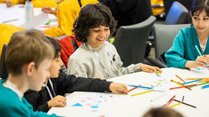 Children sat around a table learning in a classroom