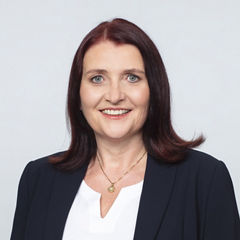 Porträt von Christiane Rohrmeister vor einer hellgrauen Wand