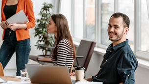 colleagues sitting around a table in an office