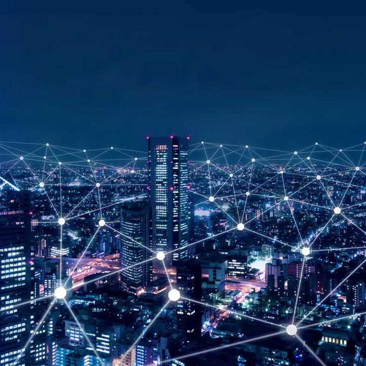 City at night with digital connected network points overlaid