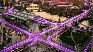 City at sunset connected by glowing purple digital network lines
