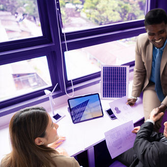 Three people in a meeting shaking hands