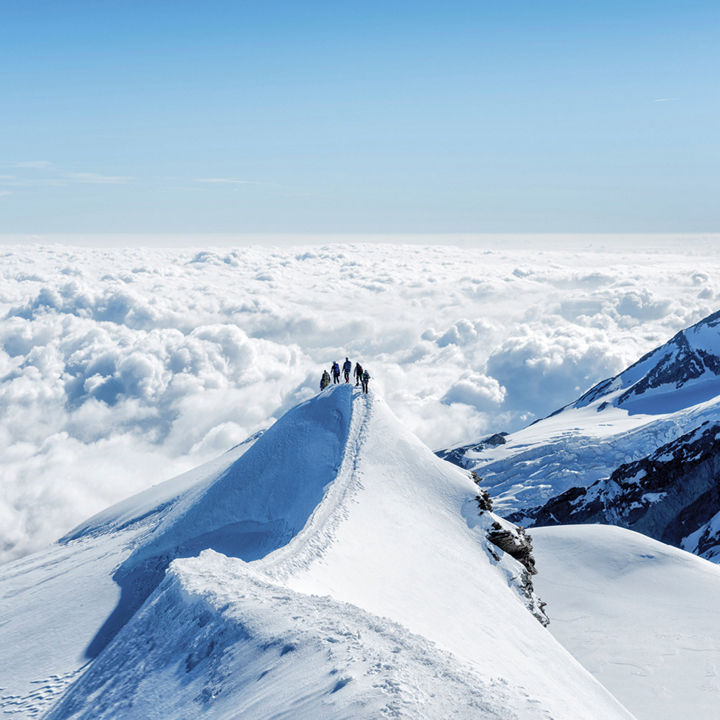 Climbers on a snow covered mountain peak legal services