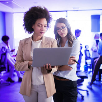 Two collegues looking at laptop