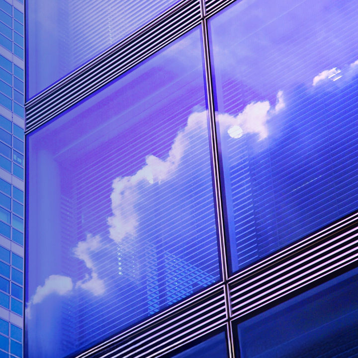 Clouds reflected in the window of a commercial high rise building