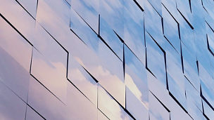 clouds reflected on glass office building