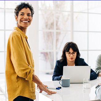 Colleagues in meeting smiling