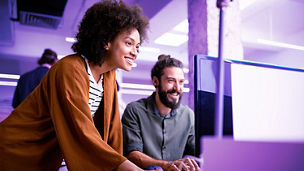 colleagues looking at computer