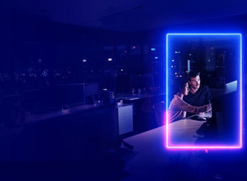 Colleagues working at computer in office at night