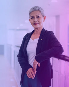 Keeping us up at night – Confident mature middle-aged Asian businesswoman standing in a modern workplace.