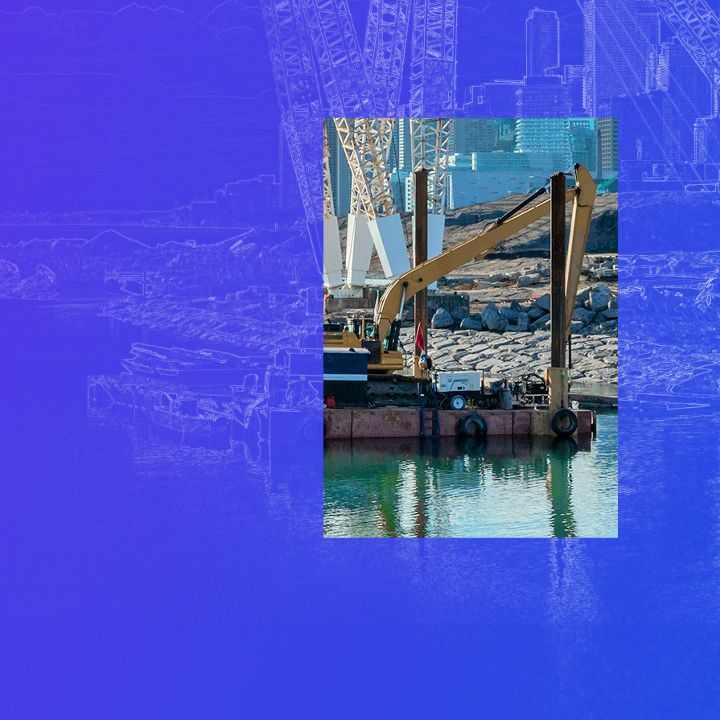 Excavator on a construction barge building a bridge banner