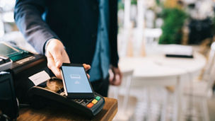 Man paying with smartphone using NFC.